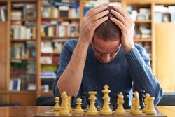 Memory loss and Alzheimer problem. Senior man devastated over chess board