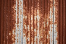Full frame shot of a weathered and rusty corrugated iron roof, suitable as a industrial background texture