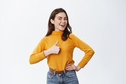 Excellent job. Smiling proud woman showing thumb up and say yes, nod to agree or approve, praising good work or nice choice, standing against white background.