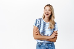 Beautiful happy girl laughing and smiling. Modern scandinavian woman posing against white background, looking happy, wearing summer clothes