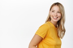 Portrait of happy modern woman, beautiful girl with white smile, bloind hair and clear natural skin without makeup, standing over white background