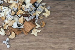Dry white, brown and beige flowers in the wooden background, space for text 
