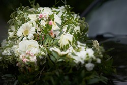 A closeup shot of decorative white bouquets on a car