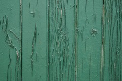 Old green wooden wall with cracked paint, background texture. High quality photo