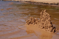 sand castle on the beach near the water. High quality photo