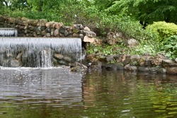 artificial waterfall in public park . High quality photo