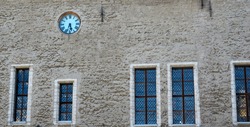 Facade of an old building with windows and an old clock. High quality photo