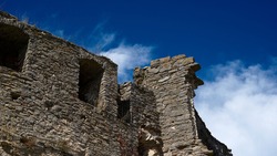 Ruins of an old castle against a blue sky. High quality photo