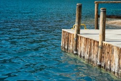 A wooden bridge extends into the sea. Selective focus. High quality photo