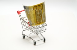 European currency. 200 (Two hundred) Euro in shopping cart on a white background. High quality photo