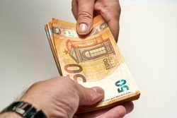 Close-up of two hands of people exchange a 50 euro notes to buy and sell. High quality photo