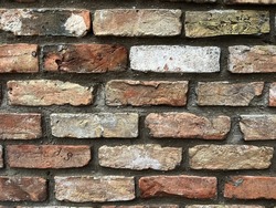 Old brick wall background, brick wall texture, structure. old broken brick, cement joints, close-up. crumbling from old age. construction, repair. concept of devastation, decline. High quality photo