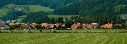 Beautiful summer in the European village - green field view on the background of country houses. High quality photo