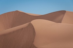 The beauty of an arid desert is captured in this balanced image of sand dunes at Algodones Dunes in southern California.