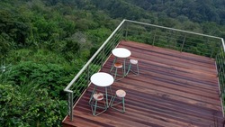 Cafe exterior with wooden decking, is a floor covering material made of wood which is generally used for out door areas that are often exposed to rain and sun.