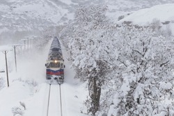 diesel train (Orient Express) is moving in the snow-covered railway platform from the capital city of Turkey; Ankara to Kars eveyday. It is very popular on winter holidays.