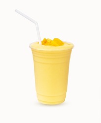 Fresh Mango ripe organic yellow smoothie honey mix with Straw in plastic glass, Garnish. Ripe mangoes are popular all over world. Perfect for summer drink. Healthy food. Isolated on white background.