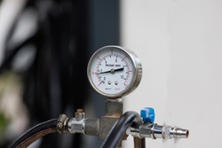 industry pressure gauge in facory background.