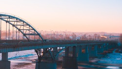panorama of transport on the bridge and sunrise over the Belaya River in Ufa, Bashkiria, Russia