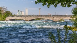 Historic pedestrian bridge to Goat Island at Niagara Falls State Park in New York, USA. 
New York State parks system plans to turn off the American falls to replace two old stone arch bridges.
