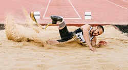 athlete disabled amputee on prosthetic long jump in para athletics