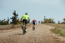 group cyclist biking mountain bike on uphill