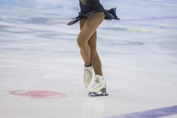 slender legs of girl skater. competitions in figure skating, performance of young athletes