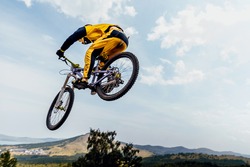 cyclist rider jump downhill mountain biking
