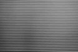 Metal corrugated background with free space for text. Gray wavy grooved metal texture, copy space