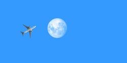 Passenger airplane in the clear sky. airplane flying towards the full moon.  ​plane with moon on blue sky as backgroun