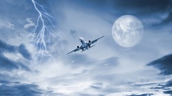 passenger plane flying at night. lightning and full moon light
