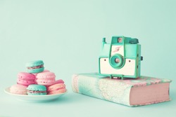 Pastel french macarons and vintage photo camera