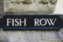 Sign plaque for Fish Row, a old street in city of Salisbury. Vintage road sign in UK.