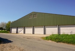 Exterior of large farmyard building. Storage barn on rural farm. Agricultural building. 