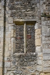 view through an ancient stone window frame. Ruins of historic abbey. 