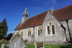 village church in English countryside. traditional stone church viewed form graveyard. quaint religious building in UK