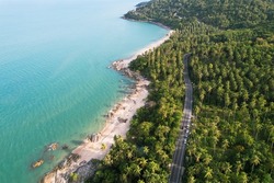 Car driving seaside road trips on holiday.Top view drone urban street road seaside during sunset.  Aerial most important beach travel summer famous landmark Phuket, Thailand. copy space 2022.
