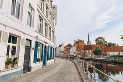 Scenic city view of Bruges canal with beautiful medieval colored houses, Belgium
