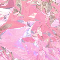 Light pastel pink colors on aluminium foil. Minimal abstract background. Creative modern flat lay concept.