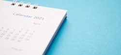 calendar page 2021 close up on blue background business planning appointment meeting concept