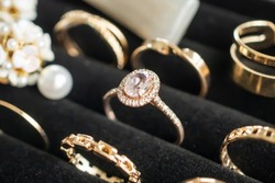 Gold jewelry diamond rings show in luxury retail store display showcase