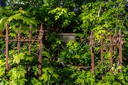 old rusty fence on the grave in the cemetery. High quality photo
