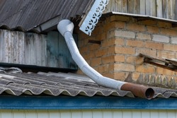 old drain pipe on the roof of the house. roof drainpipe