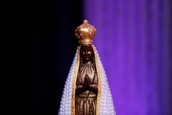 Statue of the image of Our Lady of Aparecida, mother of God in the Catholic religion, patroness of Brazil, decorated with flowers and white mantle