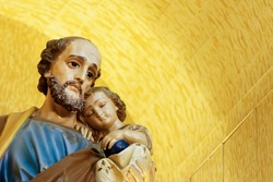 Saint Joseph and baby Jesus of the Catholic Church - Sao Jose - Menino Jesus - St Joseph yellow background
