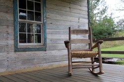 Rocking chair on the porch of an abandoned home in rural Alabama