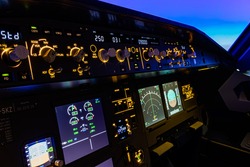 The Flight Control Unit of an commercial aircraft, with various knows and switches to control the aircraft systems. 
