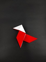 Abstract Defocused Red origami from the money heist series isolated on a black background