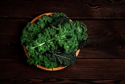 Food background, on a wooden table, top view, Fresh Kale leaves, close-up, no people, toned. selective focus,
