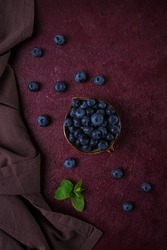 Fresh berries, Blueberries, on a maroon background, food concept, vertical, no people,
